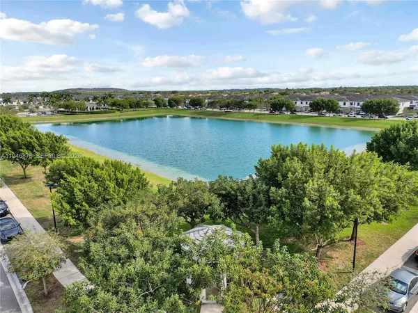 a view of a lake with houses in the back