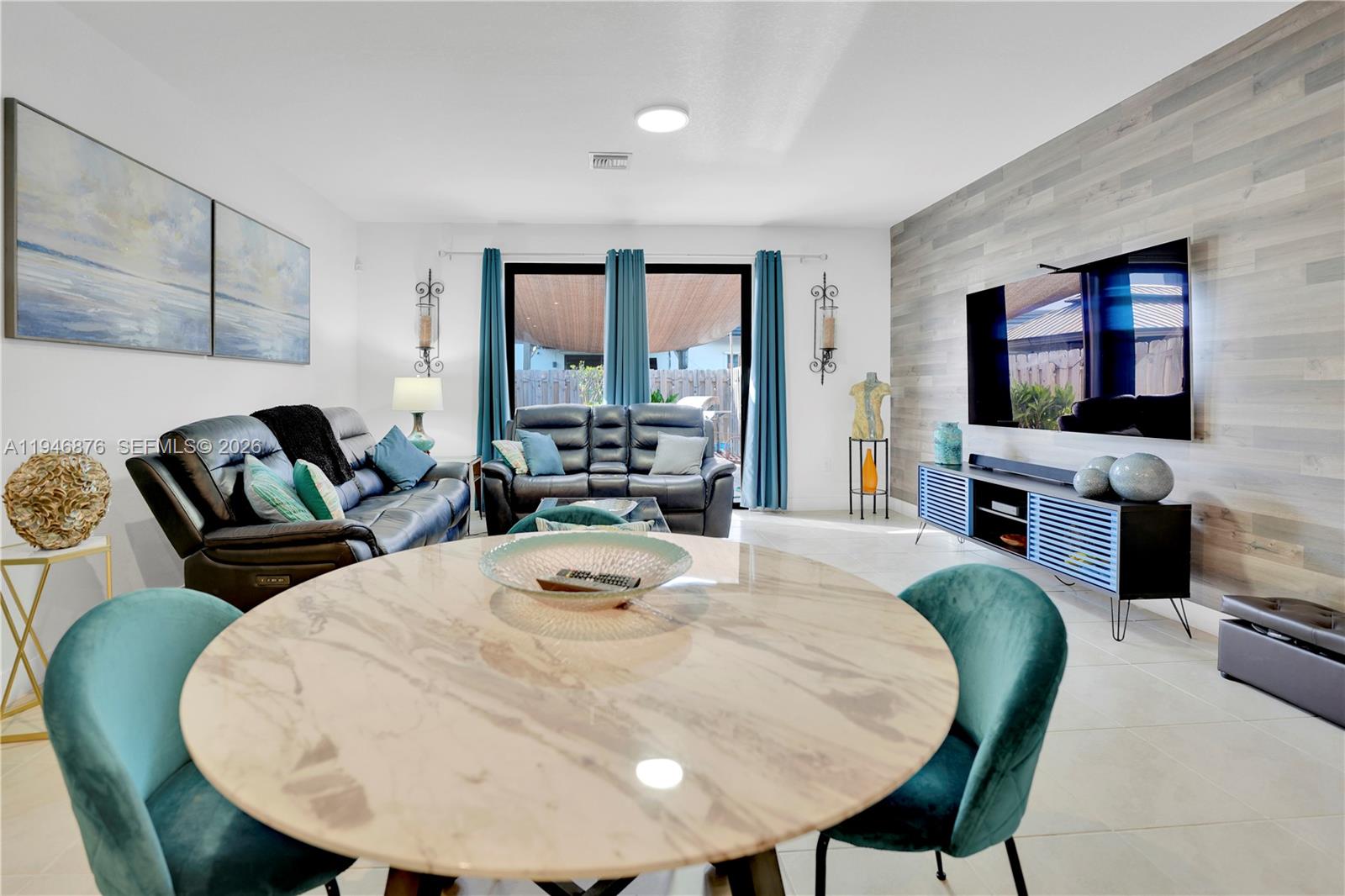 23302 Southwest 110th Avenue Homestead, FL 33032 - Photo 6 of 26 a living room with fireplace furniture and a flat screen tv