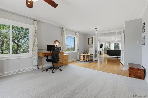 a view of a livingroom with workspace and a window