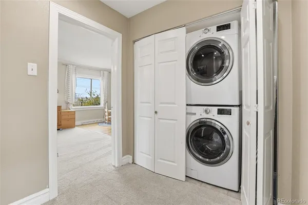 a view of a hallway with washer and dryer
