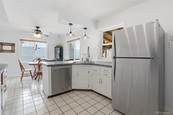 a kitchen with white cabinets and appliances
