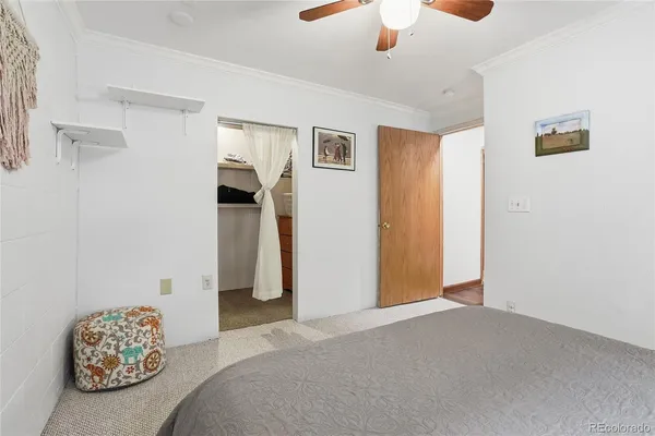 a view of a bedroom with a ceiling fan