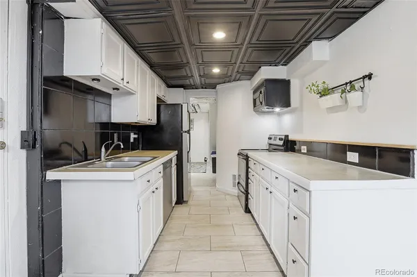 a view of a patio with a table and chairs under an umbrella