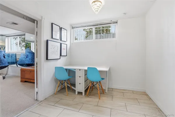 a view of a roof deck with table and chairs a barbeque with wooden floor and fence