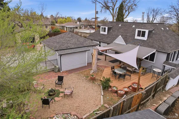 an aerial view of residential houses with outdoor space and seating