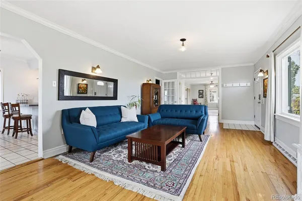a living room with furniture and a wooden floor