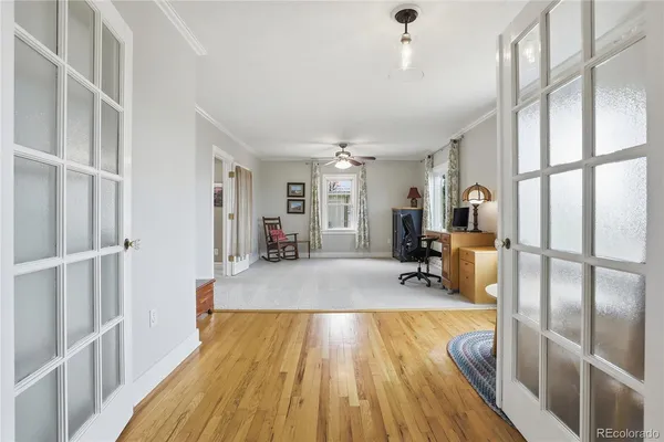 a spacious bedroom with a bed and wooden floor
