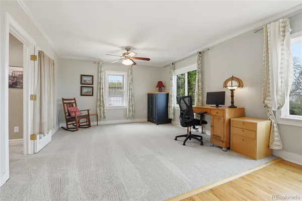a view of a livingroom with furniture and a gym cycle