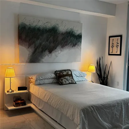 a bedroom with a bed and a potted plant