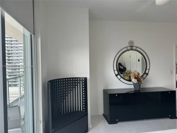 a room with painting on the wall and a window