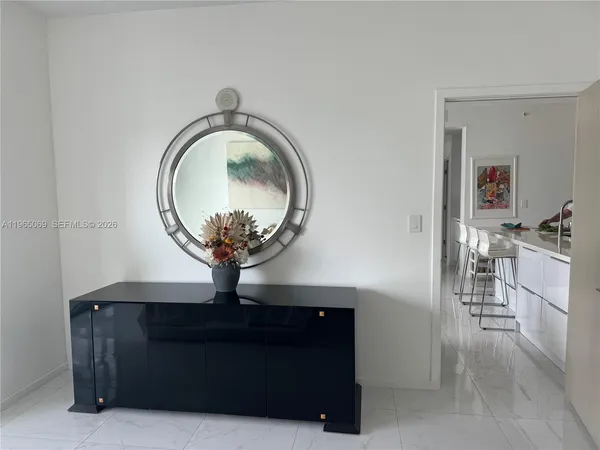 a living room with furniture and a mirror