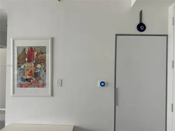 a bathroom with a painting on the wall and a shower