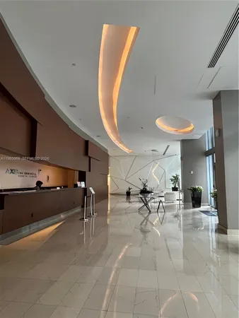 a lobby with furniture and a potted plant