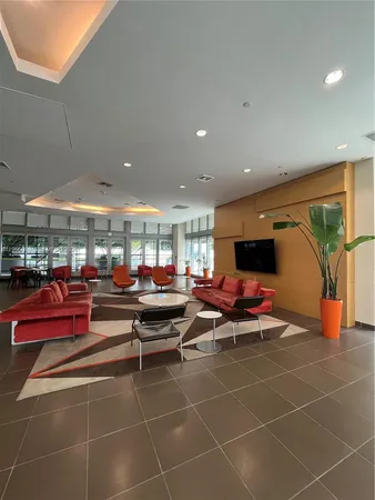 a living room with lots of furniture a rug and a projector