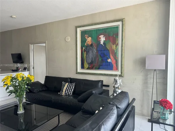 a living room with furniture flowerpot and a potted plant
