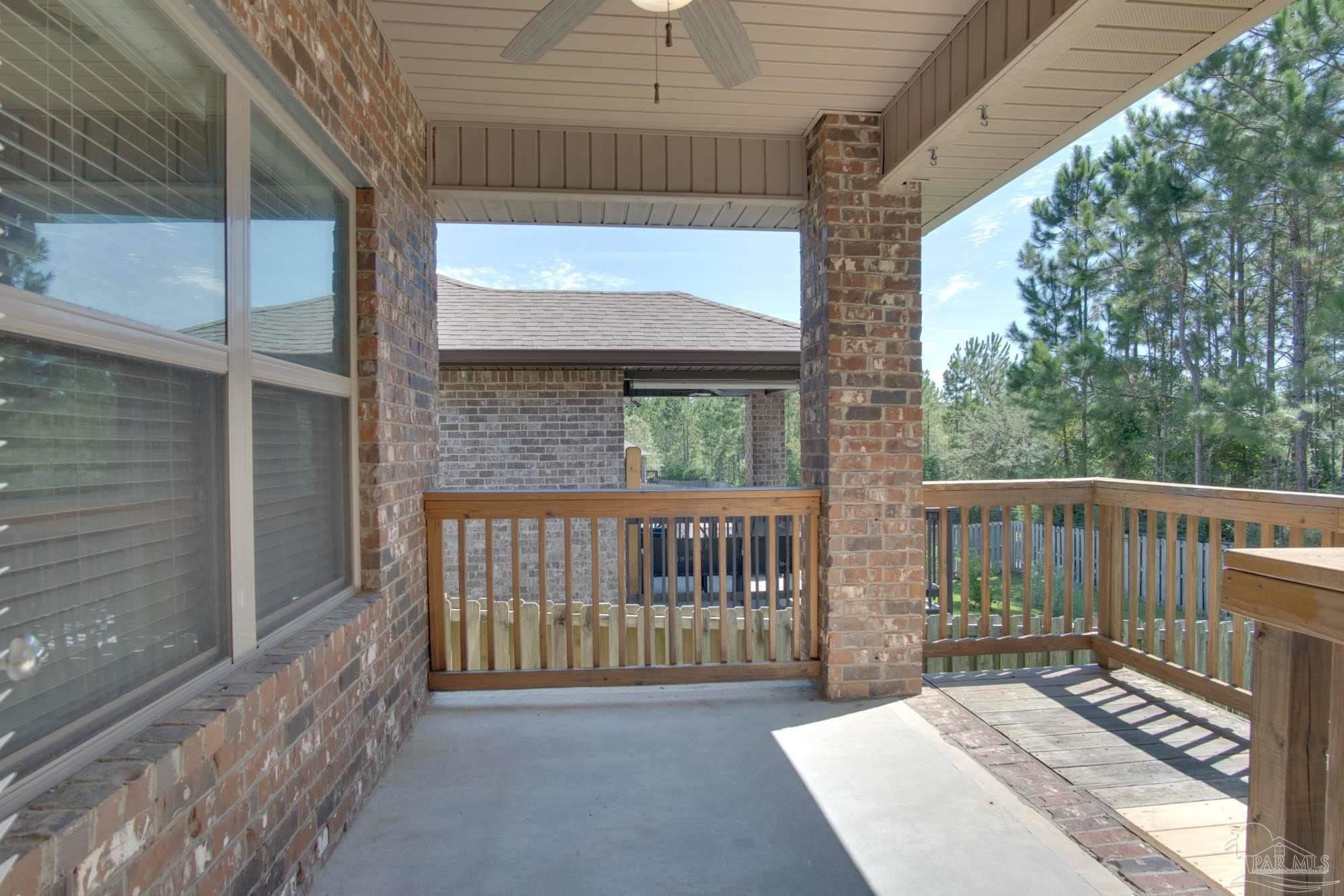 6239 Ladera Trail Pace, FL 32571 - Photo 25 of 27 a view of a porch with a small yard