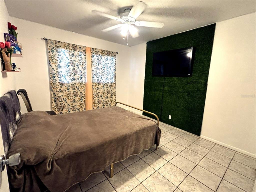 1433 South Belcher Road, Unit B2 Clearwater, FL 33764 - Photo 12 of 20 a bedroom with a bed and a television