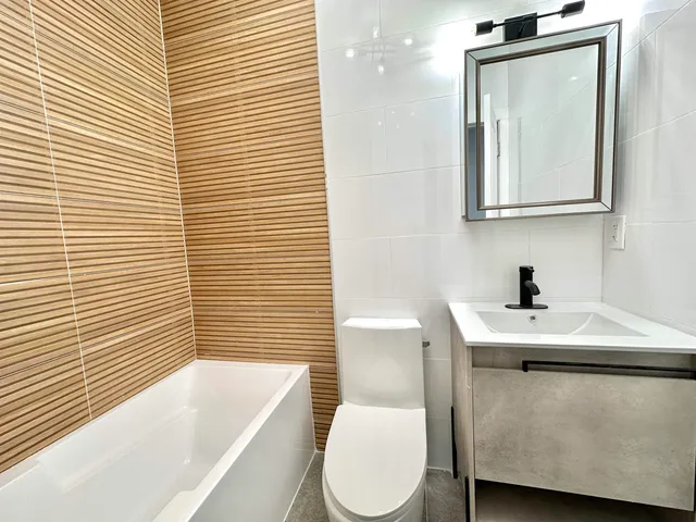 a bathroom with a sink a toilet and mirror