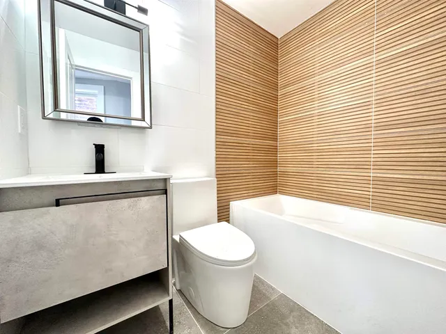 a bathroom with a toilet a sink and bathtub