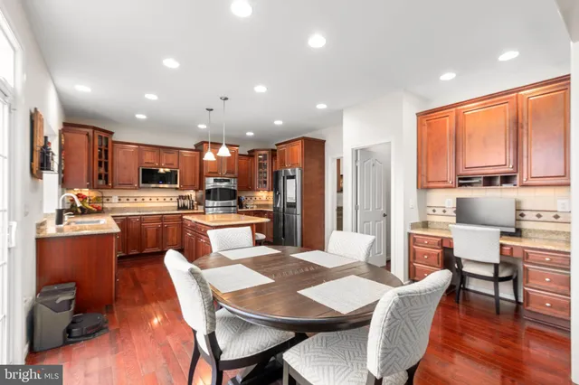 a large kitchen with a table and chairs