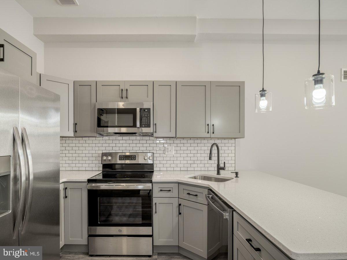 623 West Oxford Street Philadelphia, PA 19122 - Photo 12 of 39 a kitchen with a sink stainless steel appliances and cabinets