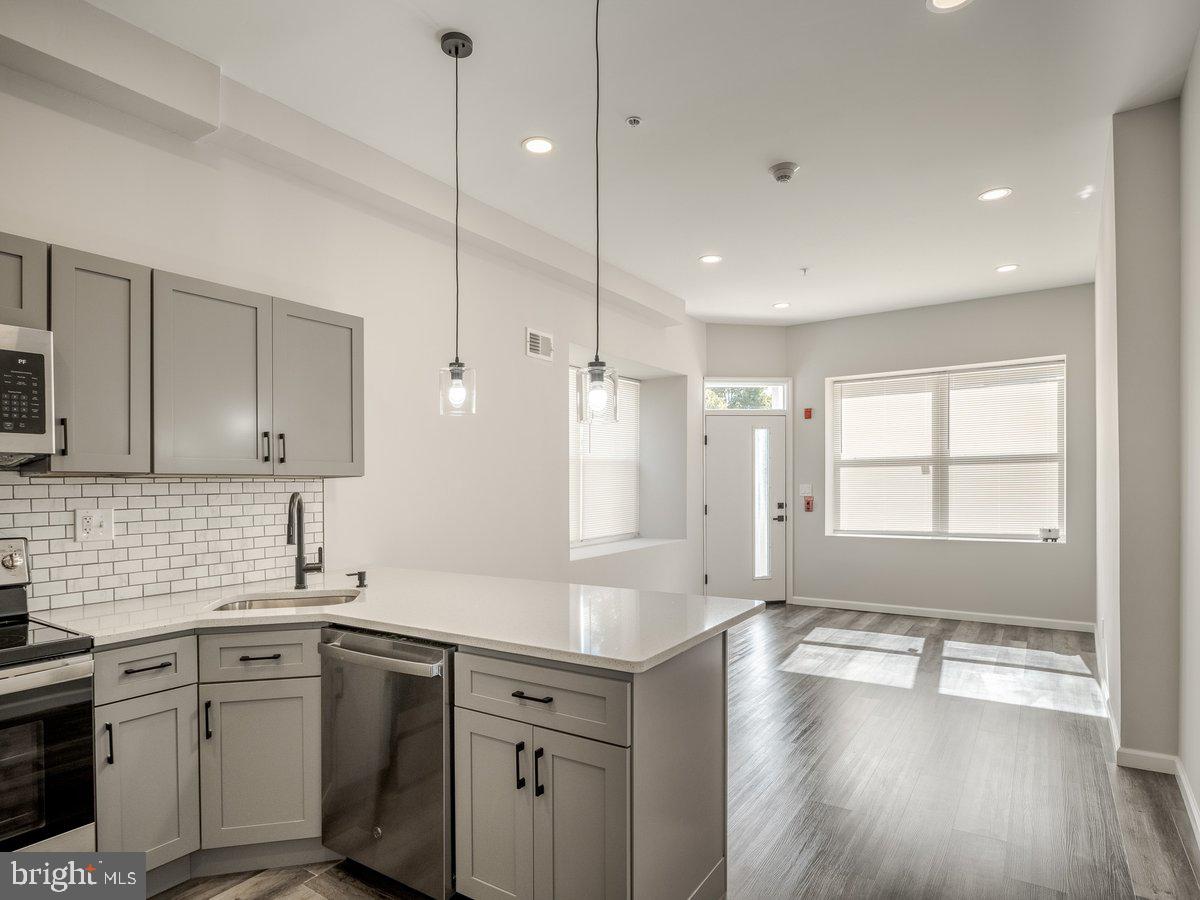 623 West Oxford Street Philadelphia, PA 19122 - Photo 13 of 39 a kitchen with a sink stove and wooden cabinets