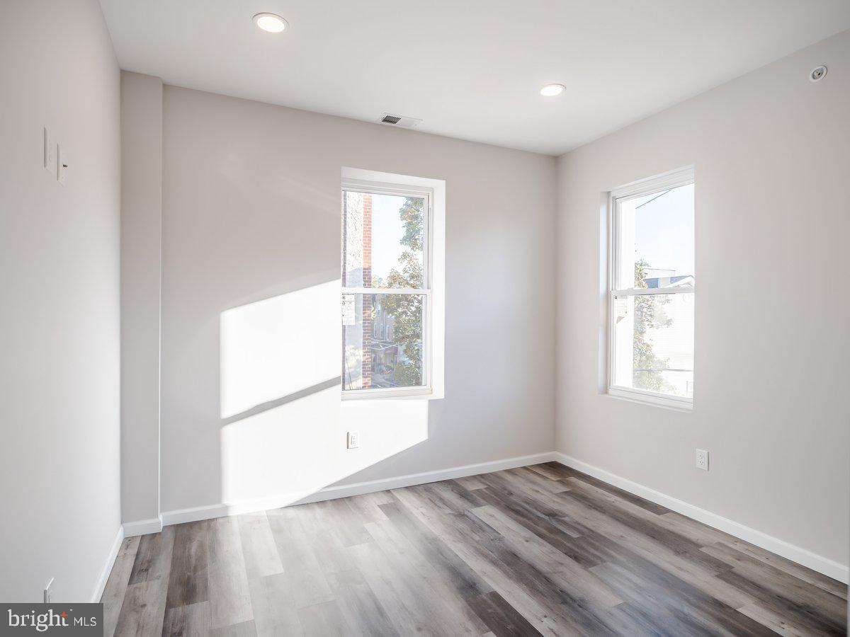 623 West Oxford Street Philadelphia, PA 19122 - Photo 16 of 39 an empty room with wooden floor and windows