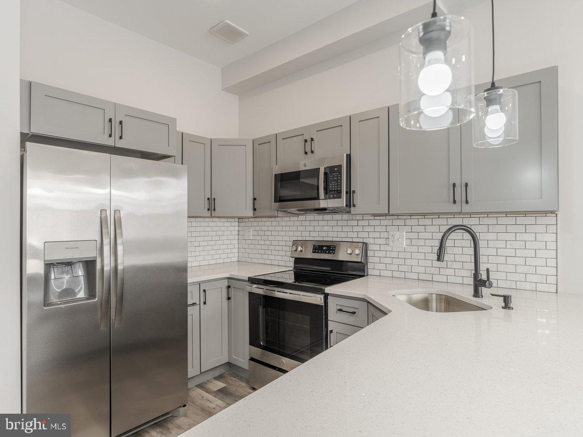 623 West Oxford Street Philadelphia, PA 19122 - Photo 2 of 39 a kitchen with a refrigerator a sink and cabinets