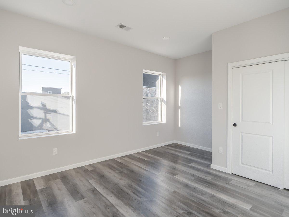 623 West Oxford Street Philadelphia, PA 19122 - Photo 22 of 39 a view of an empty room with wooden floor and a window