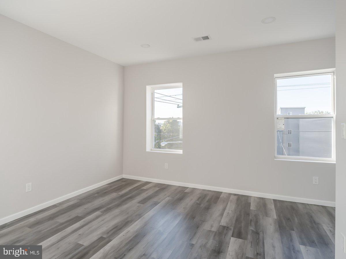 623 West Oxford Street Philadelphia, PA 19122 - Photo 23 of 39 an empty room with wooden floor and windows