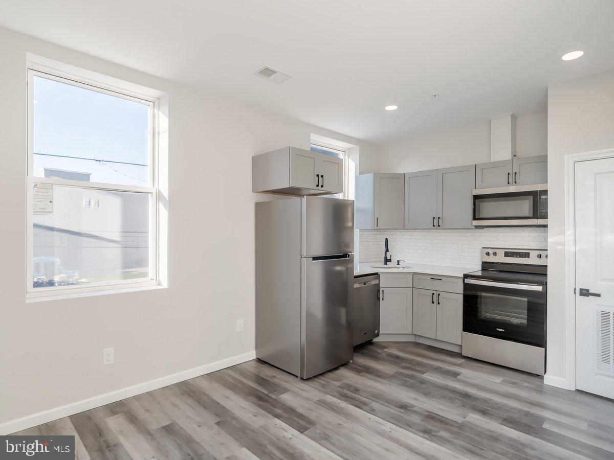 623 West Oxford Street Philadelphia, PA 19122 - Photo 30 of 39 a kitchen with a refrigerator stove and sink