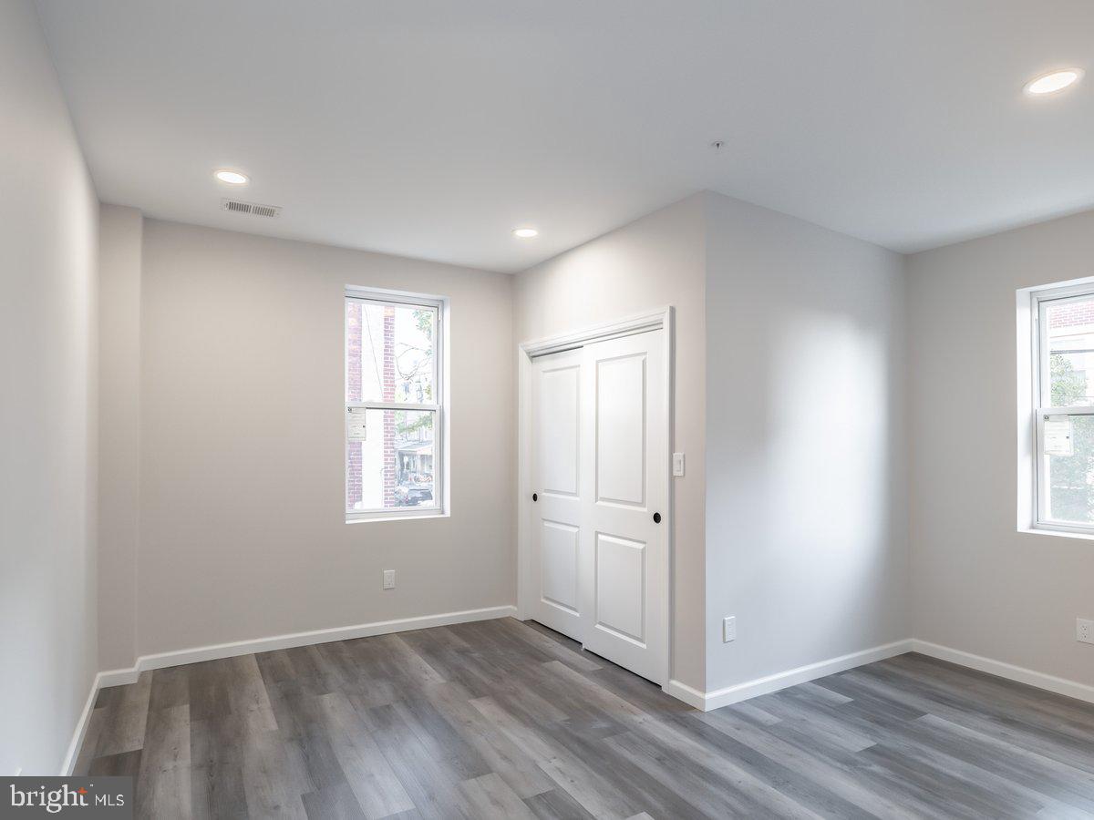 623 West Oxford Street Philadelphia, PA 19122 - Photo 33 of 39 an empty room with wooden floor and windows
