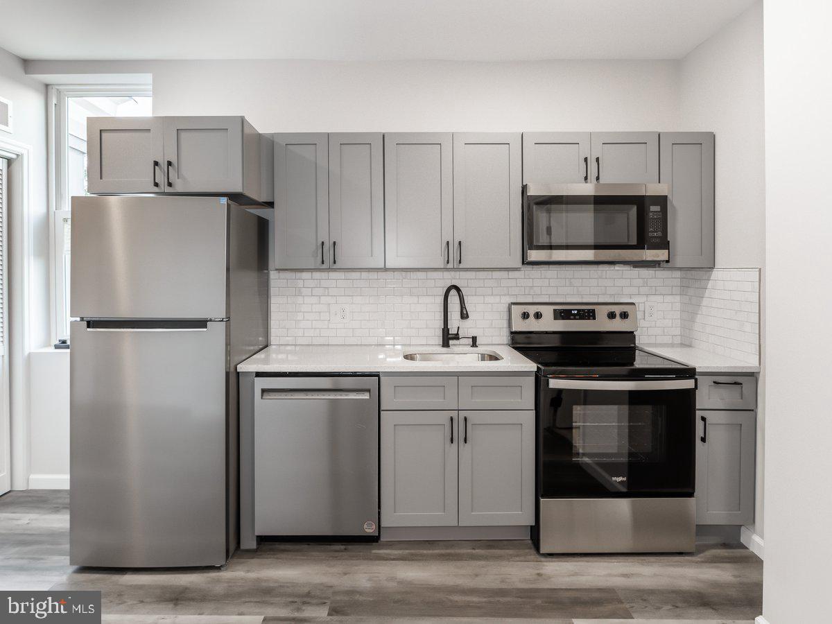 623 West Oxford Street Philadelphia, PA 19122 - Photo 36 of 39 a kitchen with stainless steel appliances a refrigerator stove and microwave