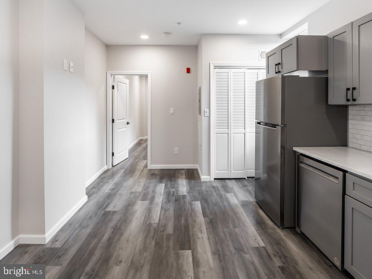 623 West Oxford Street Philadelphia, PA 19122 - Photo 37 of 39 a kitchen with a refrigerator an oven and wooden floor