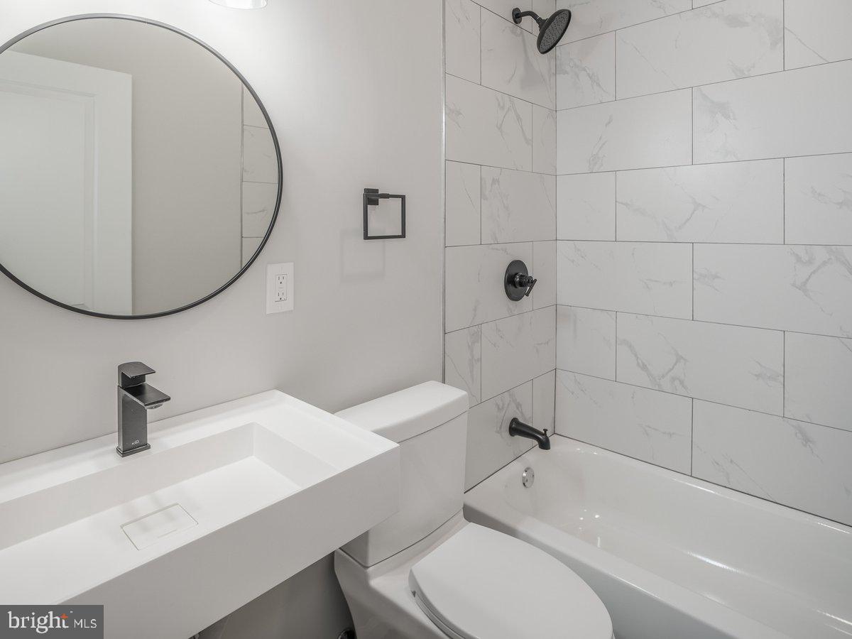 623 West Oxford Street Philadelphia, PA 19122 - Photo 7 of 39 a bathroom with a sink a toilet and a mirror