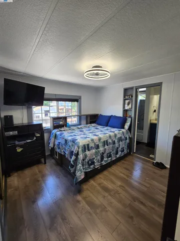 a bedroom with a bed and a couch