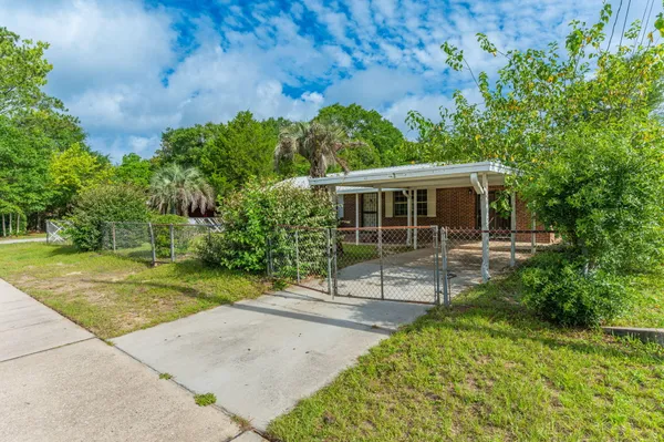 a view of a house with a yard patio and a garden
