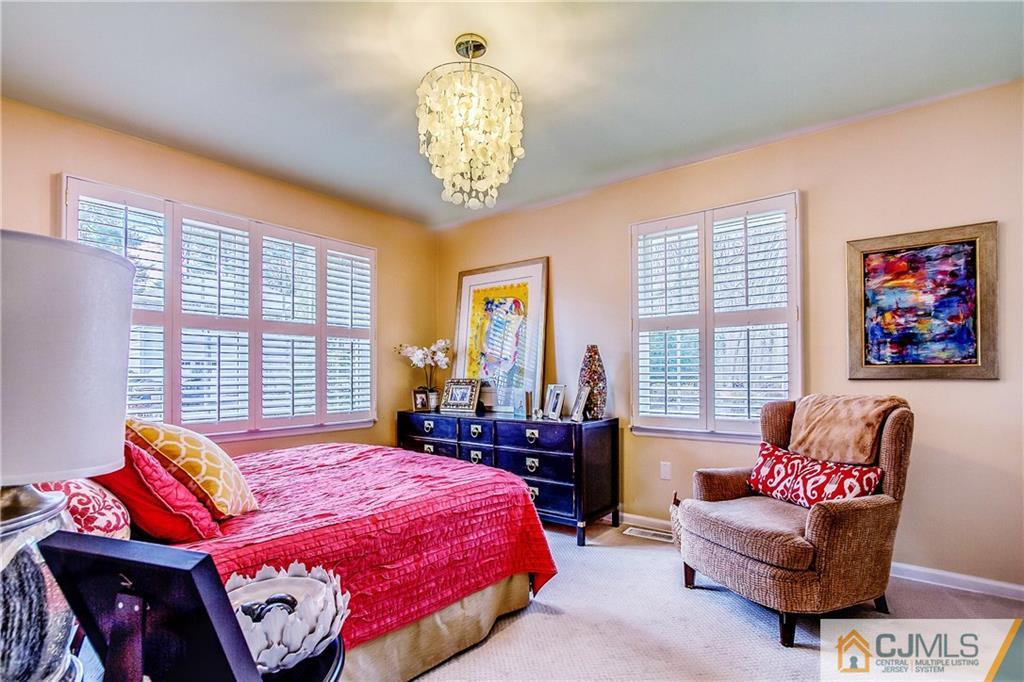 338 Springhill Road Skillman, NJ 08558 - Photo 14 of 23 a spacious bedroom with a bed and a chandelier