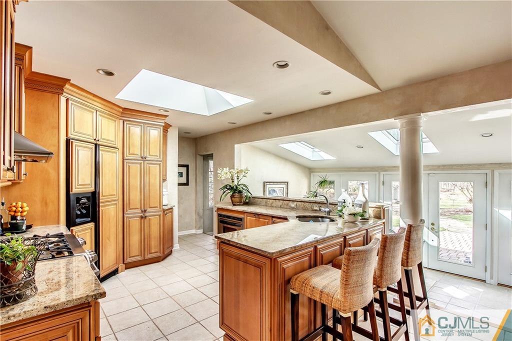338 Springhill Road Skillman, NJ 08558 - Photo 8 of 23 a open kitchen with stainless steel appliances granite countertop a stove and refrigerator