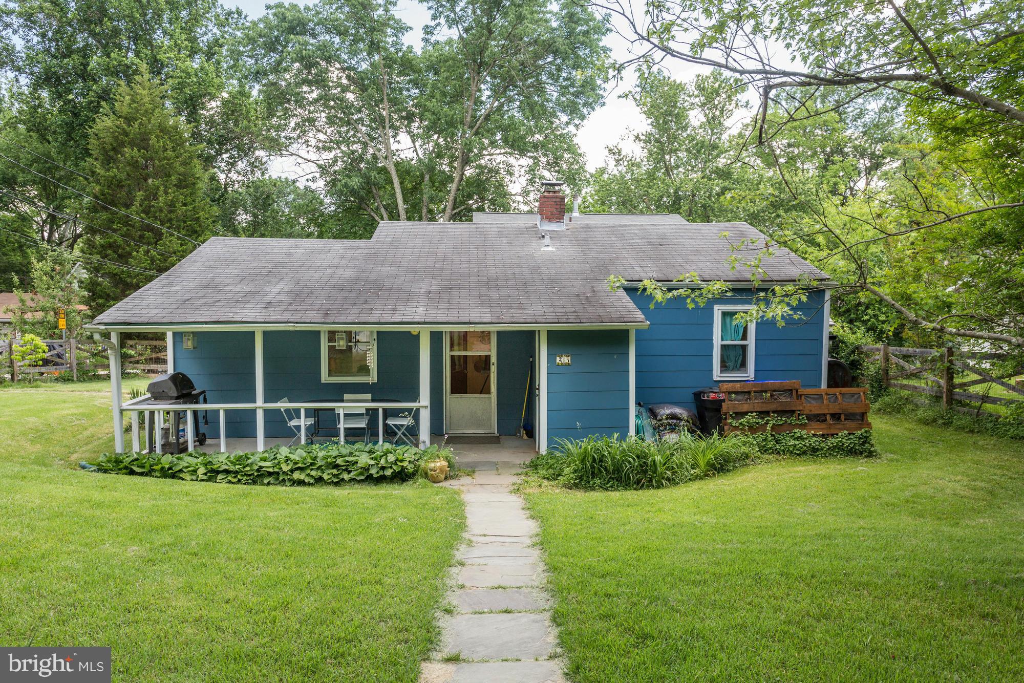 23 Ericsson Road Cabin John, MD 20818 - Photo 2 of 30 a front view of a house with a garden and porch