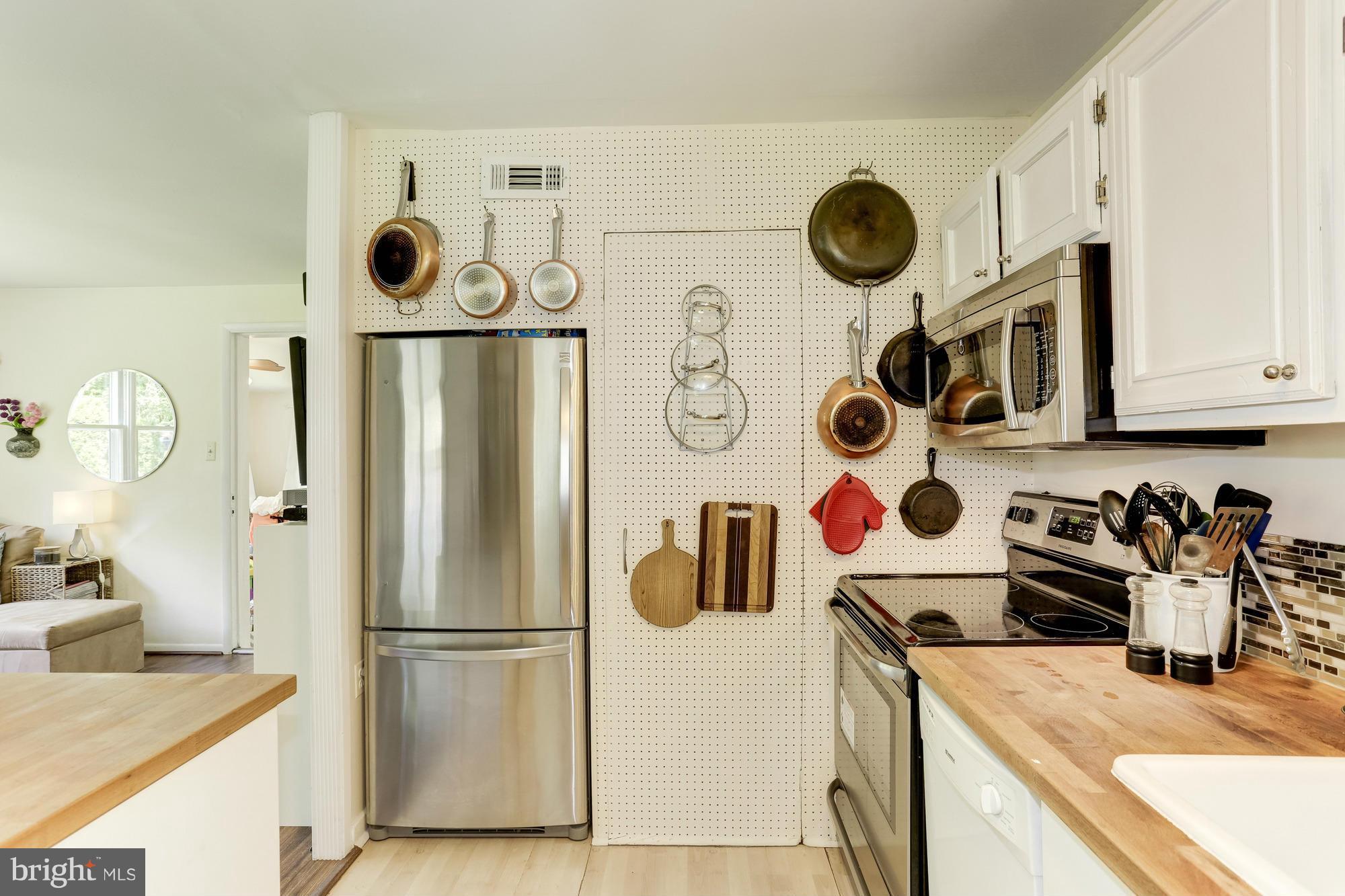 23 Ericsson Road Cabin John, MD 20818 - Photo 11 of 30 a kitchen with a refrigerator and a stove