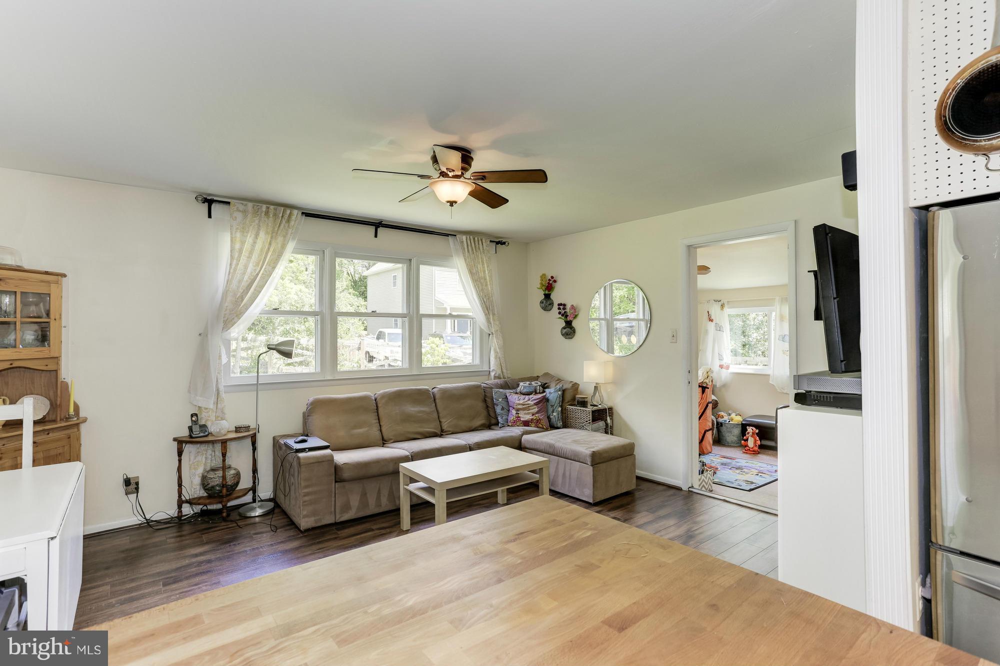 23 Ericsson Road Cabin John, MD 20818 - Photo 12 of 30 a living room with furniture a fireplace and a window