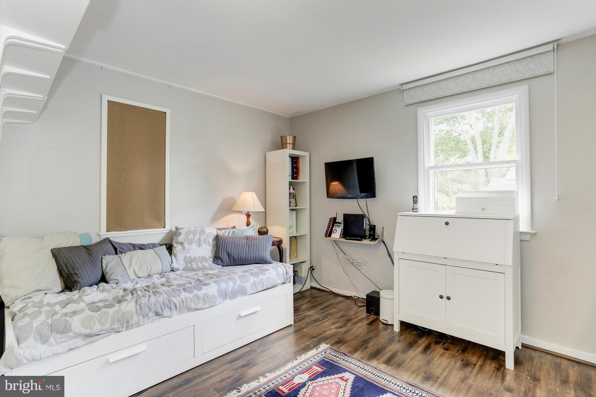23 Ericsson Road Cabin John, MD 20818 - Photo 17 of 30 a living room with furniture a flat screen tv and a window