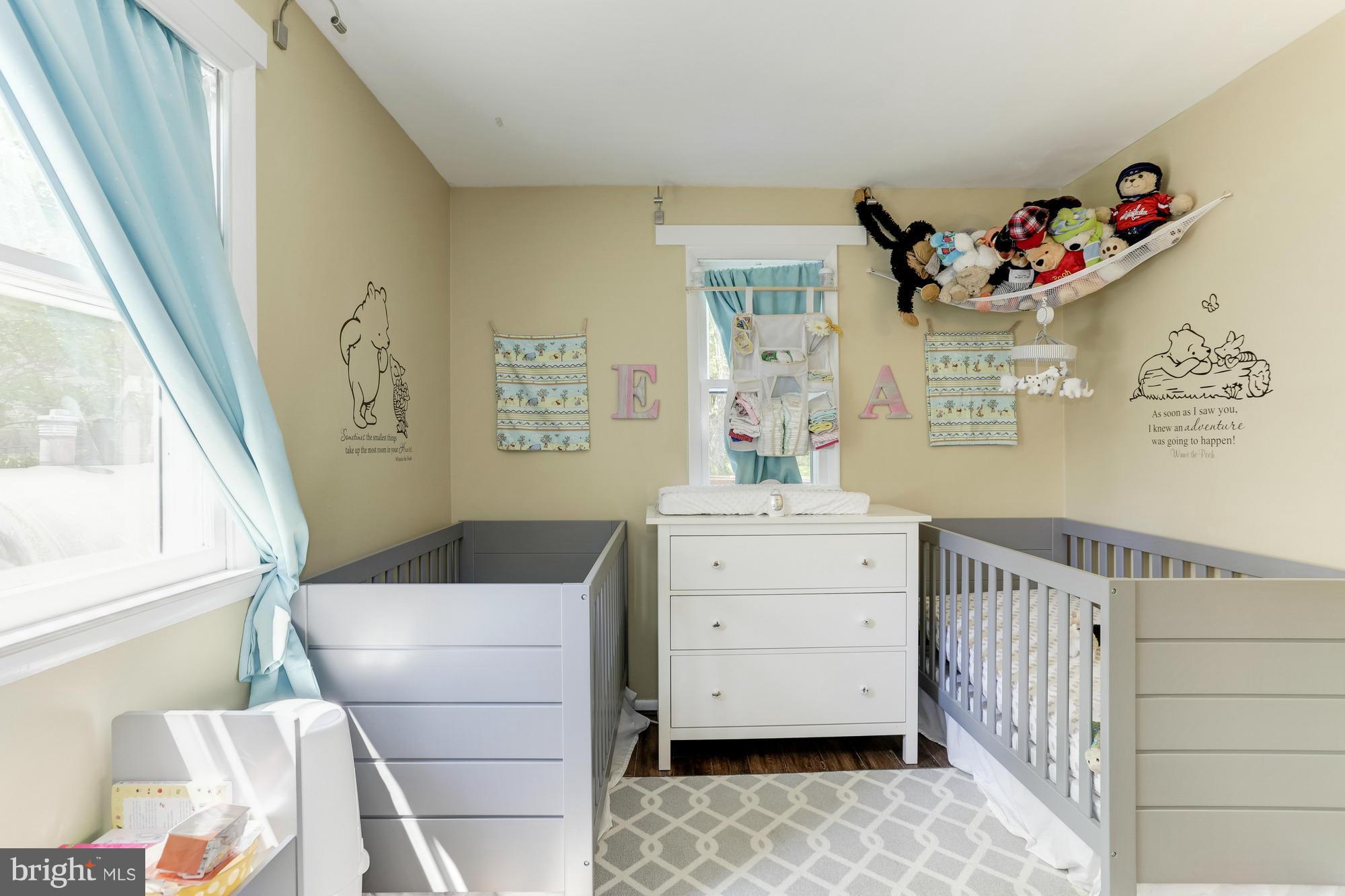23 Ericsson Road Cabin John, MD 20818 - Photo 20 of 30 a room with a baby crib cabinets and a window