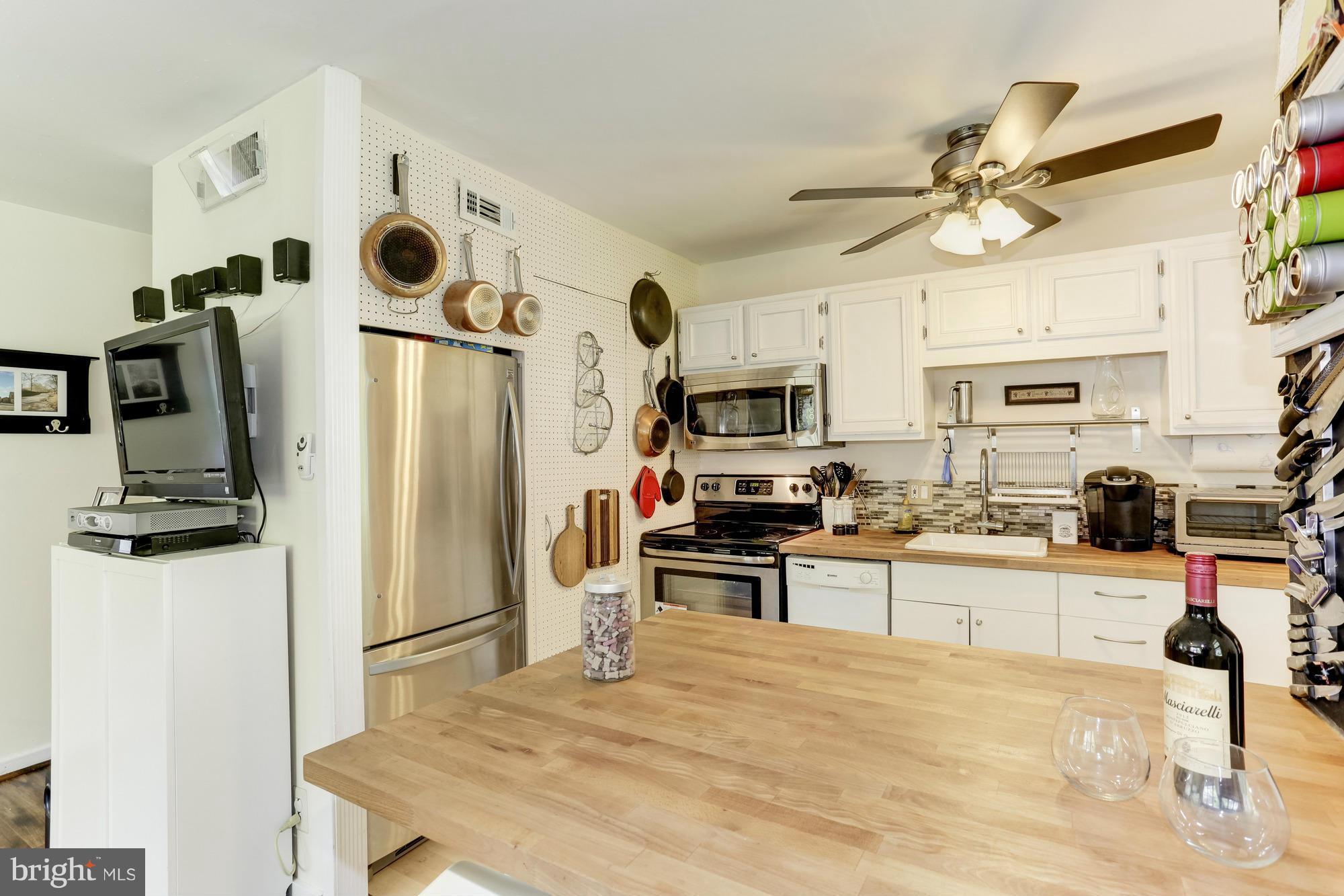 23 Ericsson Road Cabin John, MD 20818 - Photo 8 of 30 a kitchen with stainless steel appliances a stove a refrigerator and a refrigerator