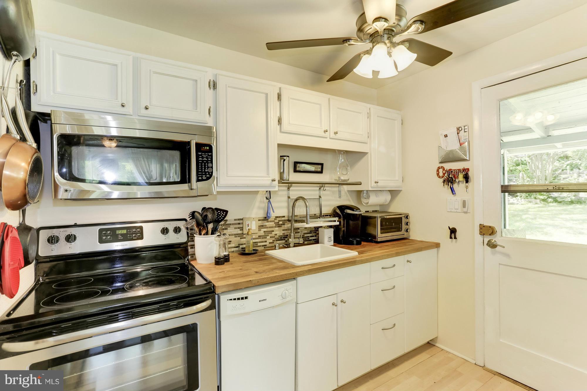 23 Ericsson Road Cabin John, MD 20818 - Photo 9 of 30 a kitchen with stainless steel appliances a stove microwave and sink