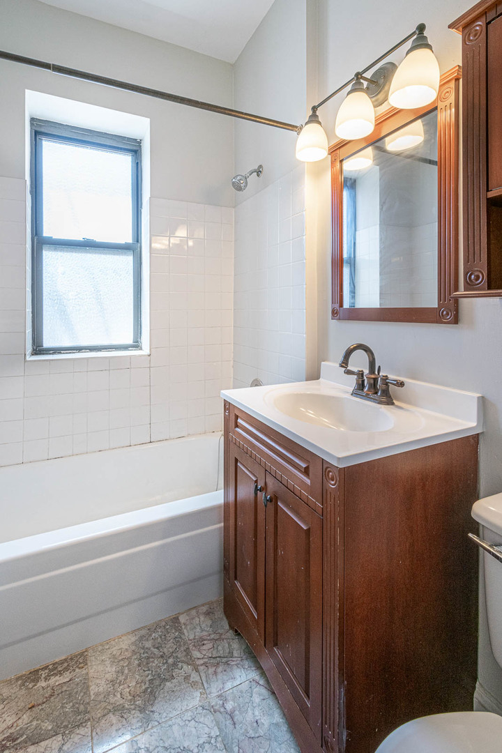 725 West Sheridan Road, Unit 206 Chicago, IL 60613 - Photo 9 of 13 a bathroom with a sink and a mirror