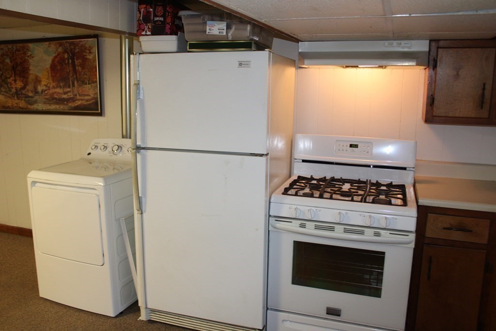 295 Draper Street Springfield, MA 01108 - Photo 24 of 31 a white refrigerator freezer and a stove sitting inside of a kitchen