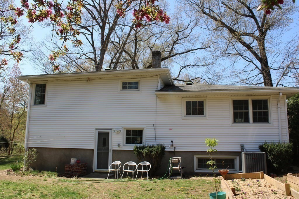 295 Draper Street Springfield, MA 01108 - Photo 4 of 31 a backyard of a house with fire pit and outdoor seating