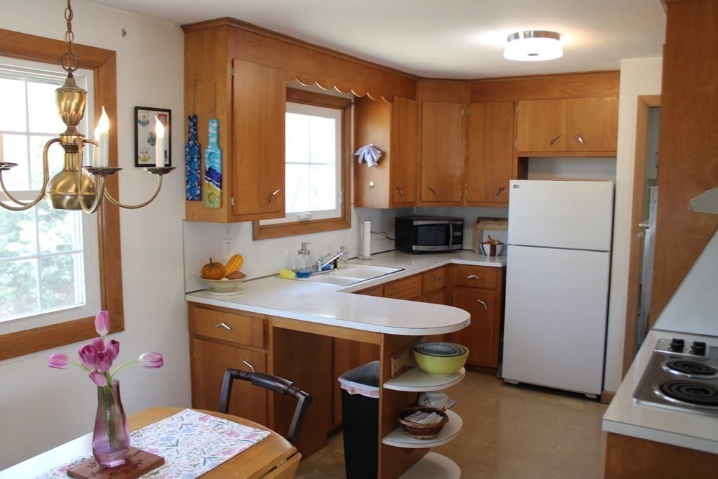 295 Draper Street Springfield, MA 01108 - Photo 6 of 31 a kitchen with stainless steel appliances granite countertop a sink refrigerator and cabinets